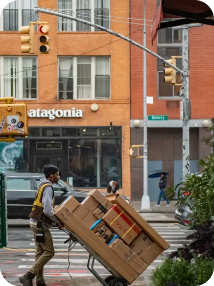 Man pushing cart of boxes Man pushing cart of boxes