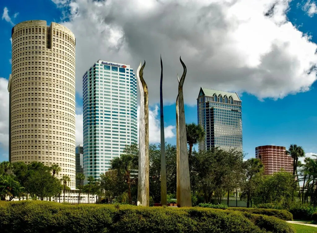 pexels-photo-208643-208643 Tampa's skyline features tall skyscrapers and modern sculptures under a bright sky.