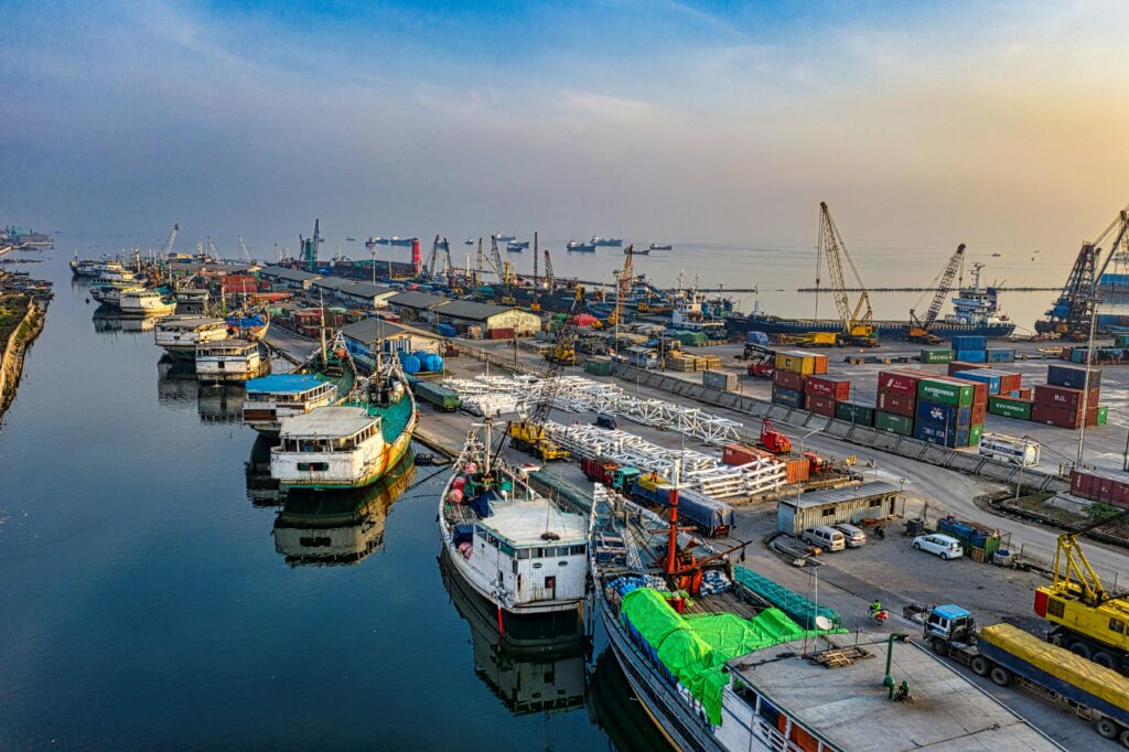 pexels-photo-3376481-3376481-1 Vibrant aerial shot of an industrial port with docked ships, cranes, and containers at dusk.