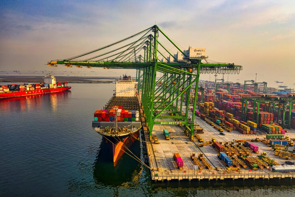 pexels-photo-3856440-3856440 A bustling aerial view of a container port in North Jakarta, Indonesia with ships and cranes.